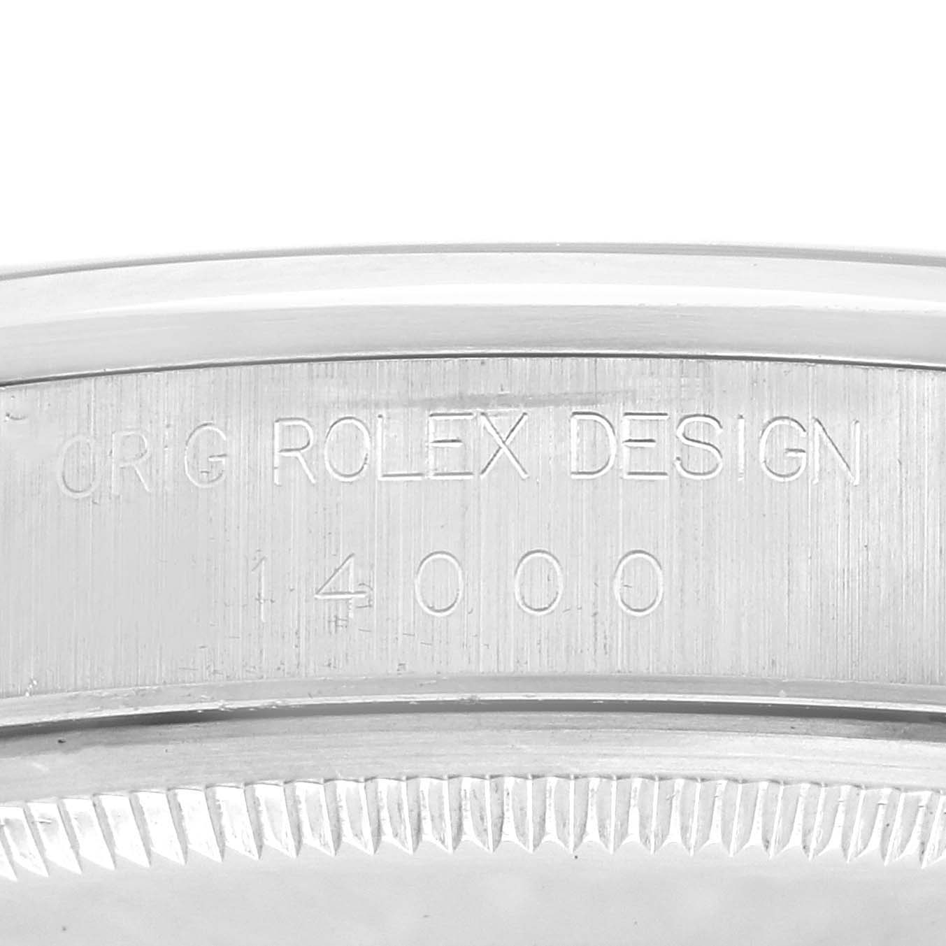 The image shows a close-up of the case side engraving on a Rolex Air-King 14000 Men
s Stainless Steel Blue Dial 14000 Men
s Stainless Steel Blue Dial watch, displaying "ORIG ROLEX DESIGN 14000."