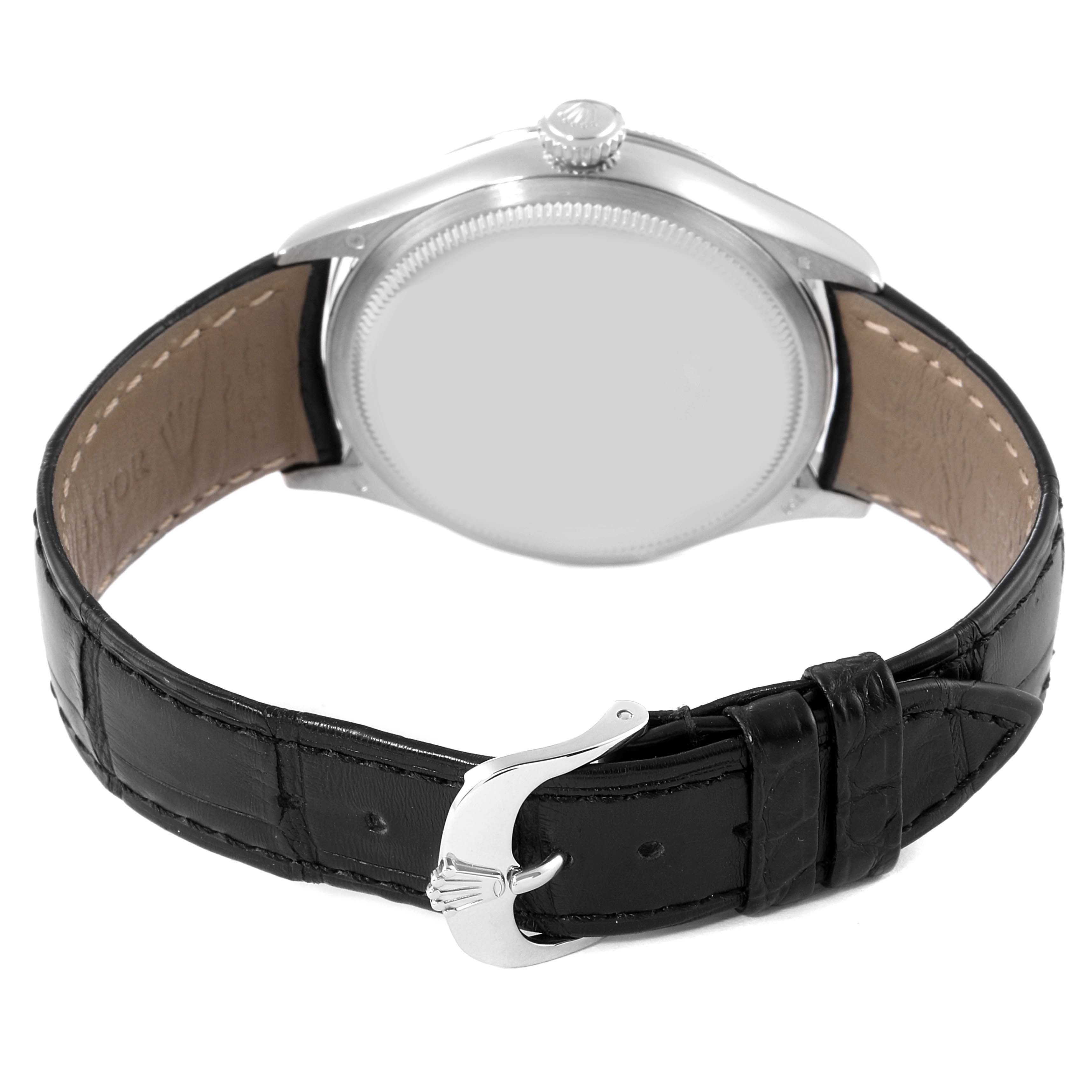 The image shows the back view of a Rolex Cellini 50509 Men
s Stainless Steel Silver Dial 50509 Men
s Stainless Steel Silver Dial watch, including the case, crown, and leather strap with a buckle.