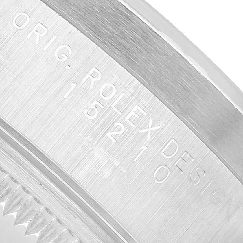 The image shows a close-up of the engraved side of the Rolex Date 15210 Men's Stainless Steel Black Dial watch case.