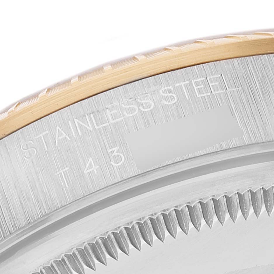 This close-up image shows the edge of the bezel and case side with markings of a Rolex Date 15223 Men's Steel and Gold (two tone) Grey Dial 15223 Men's Steel and Gold (two tone) Grey Dial model watch.