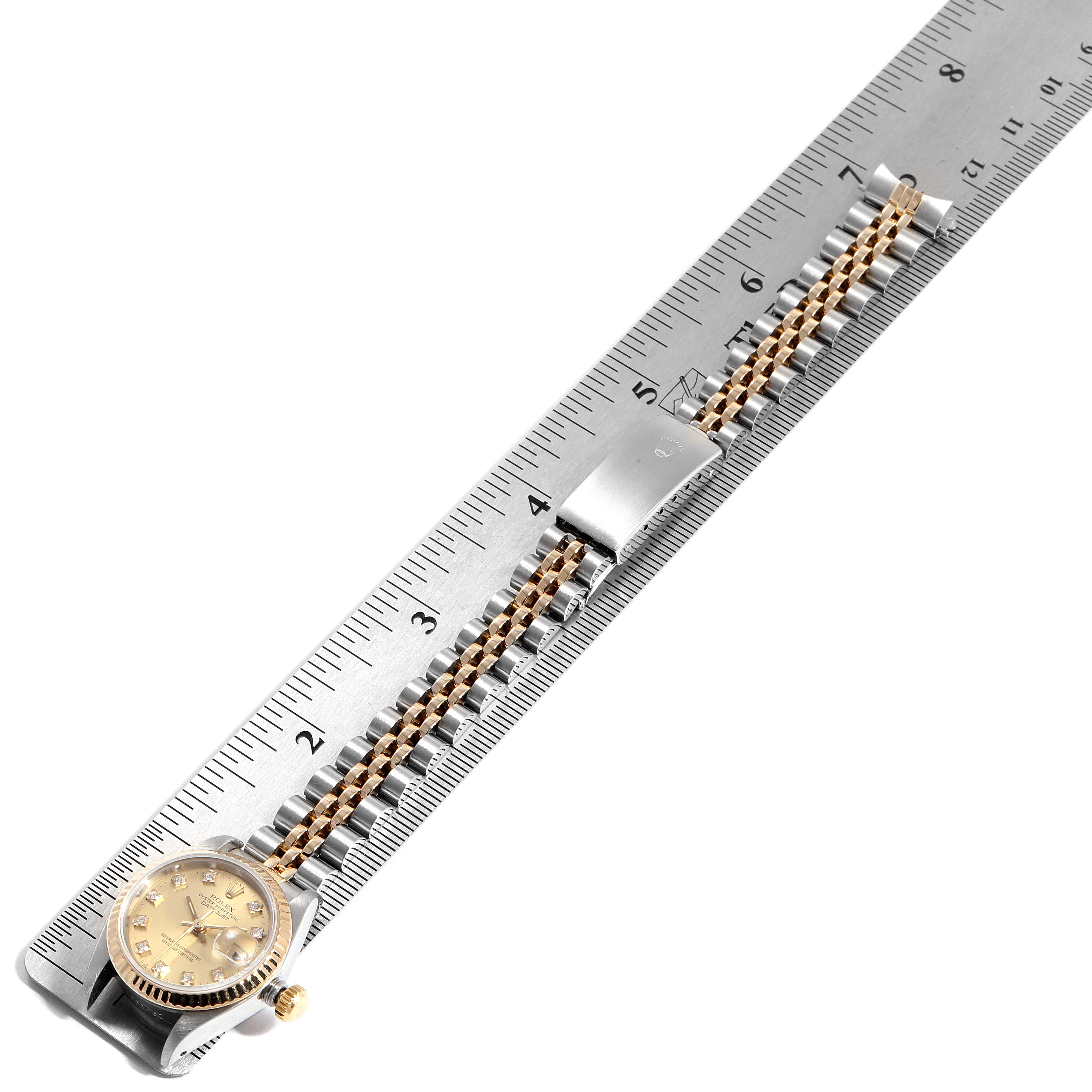 The image shows a top-down view of a Rolex Datejust 69173 Women's Steel and Gold (two tone) Champagne Dial 69173 Women's Steel and Gold (two tone) Champagne Dial watch with its bracelet extended, laid on a ruler for measurement.
