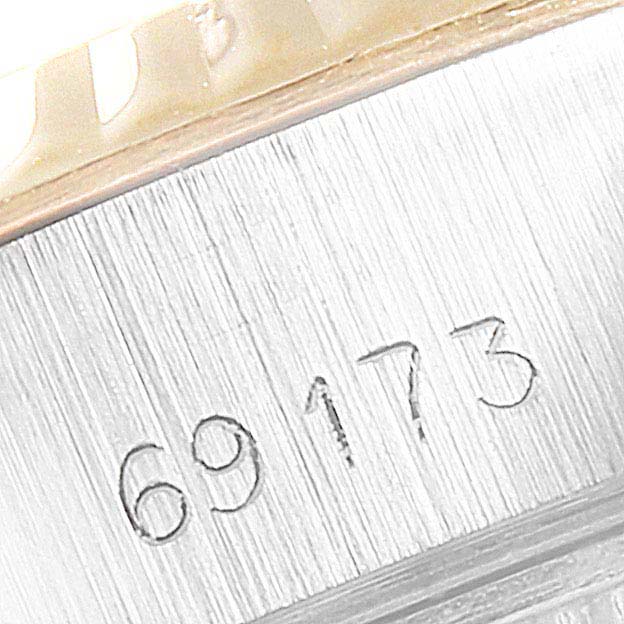 This is a close-up shot of a Rolex Datejust 69173 Women's Steel and Gold (two tone) Champagne Dial 69173 Women's Steel and Gold (two tone) Champagne Dial model, showing the serial number etched into the case.
