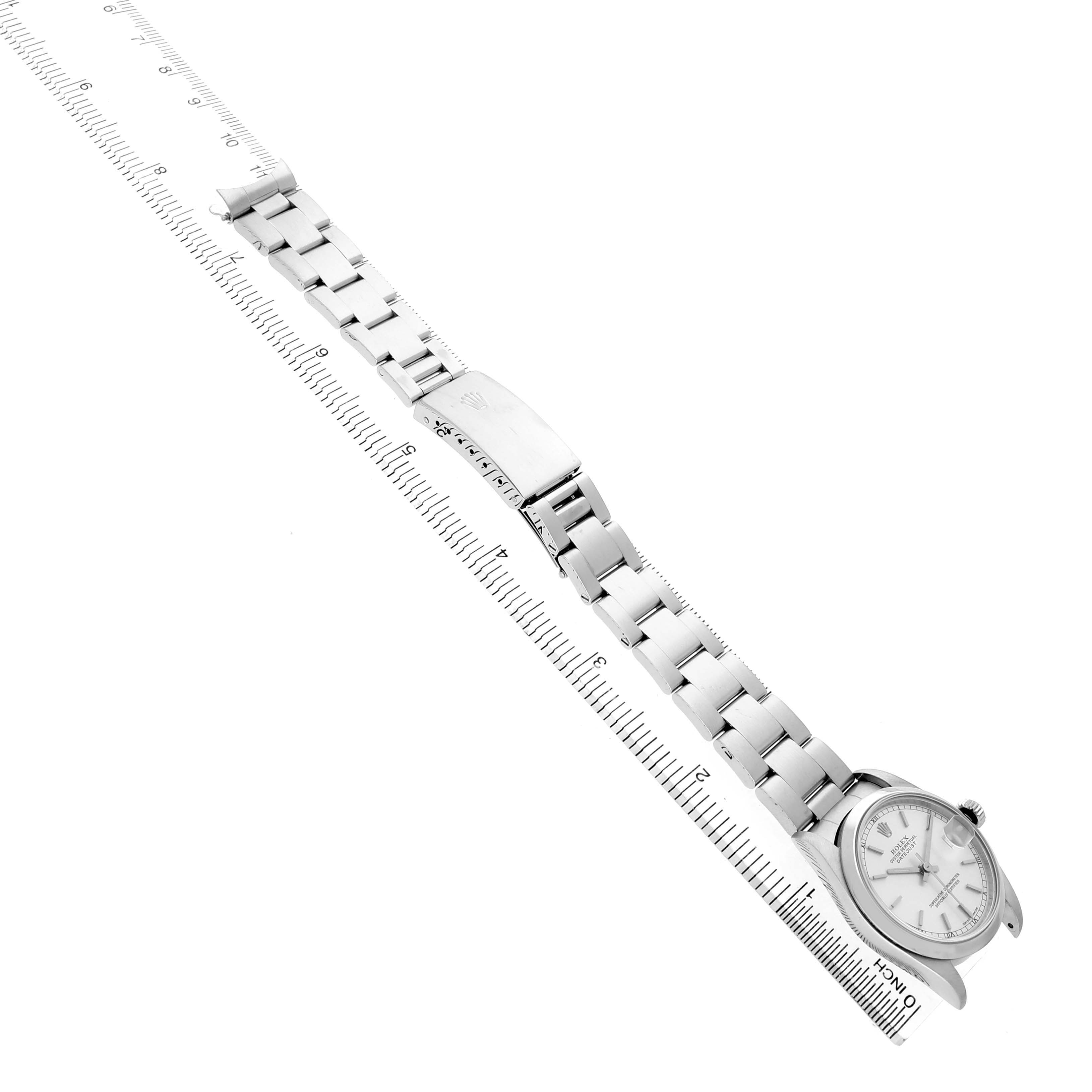 The image shows a Rolex Datejust 78240 Women's Stainless Steel Silver Dial watch from a side angle, highlighting its bracelet, clasp, and face alongside a ruler.