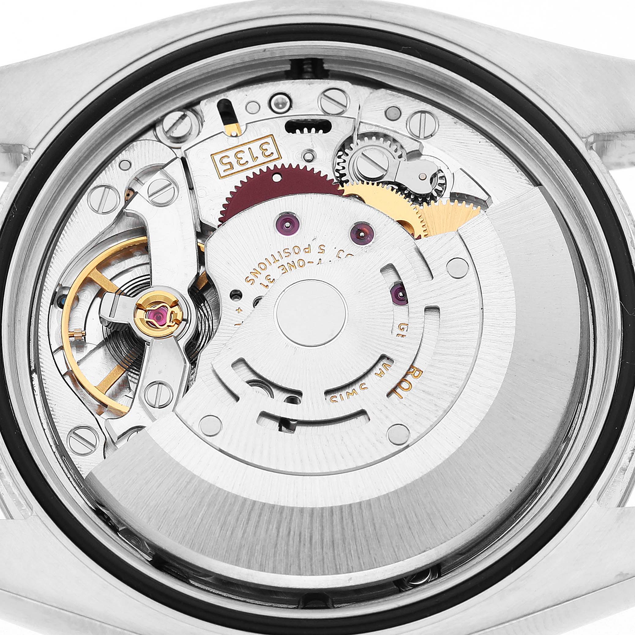 The image shows the movement of a Rolex Datejust 116234 Men's Stainless Steel Silver Dial watch from the back, highlighting its intricate components and mechanism.