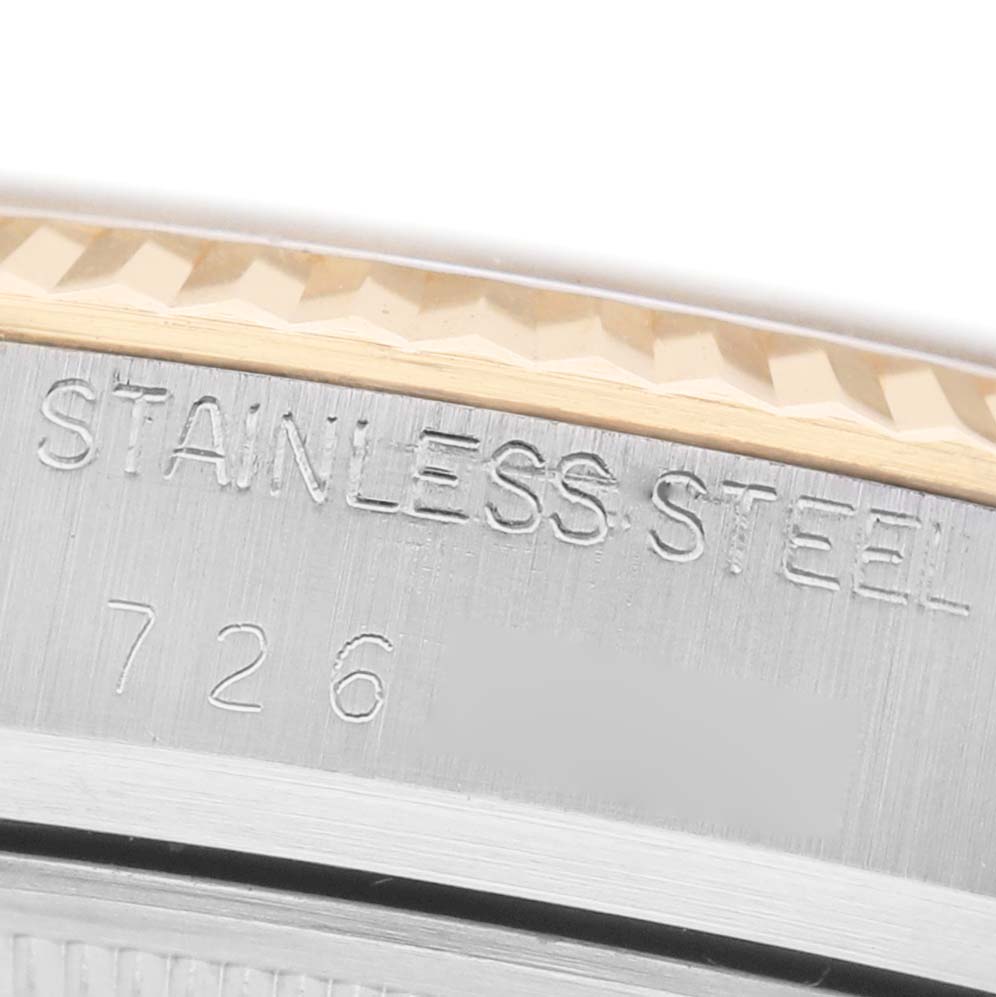 The image shows a close-up of the side of a Rolex Datejust 16013 Men's Steel and Gold (two tone) Champagne Dial watch, highlighting the stainless steel casing with engravings.