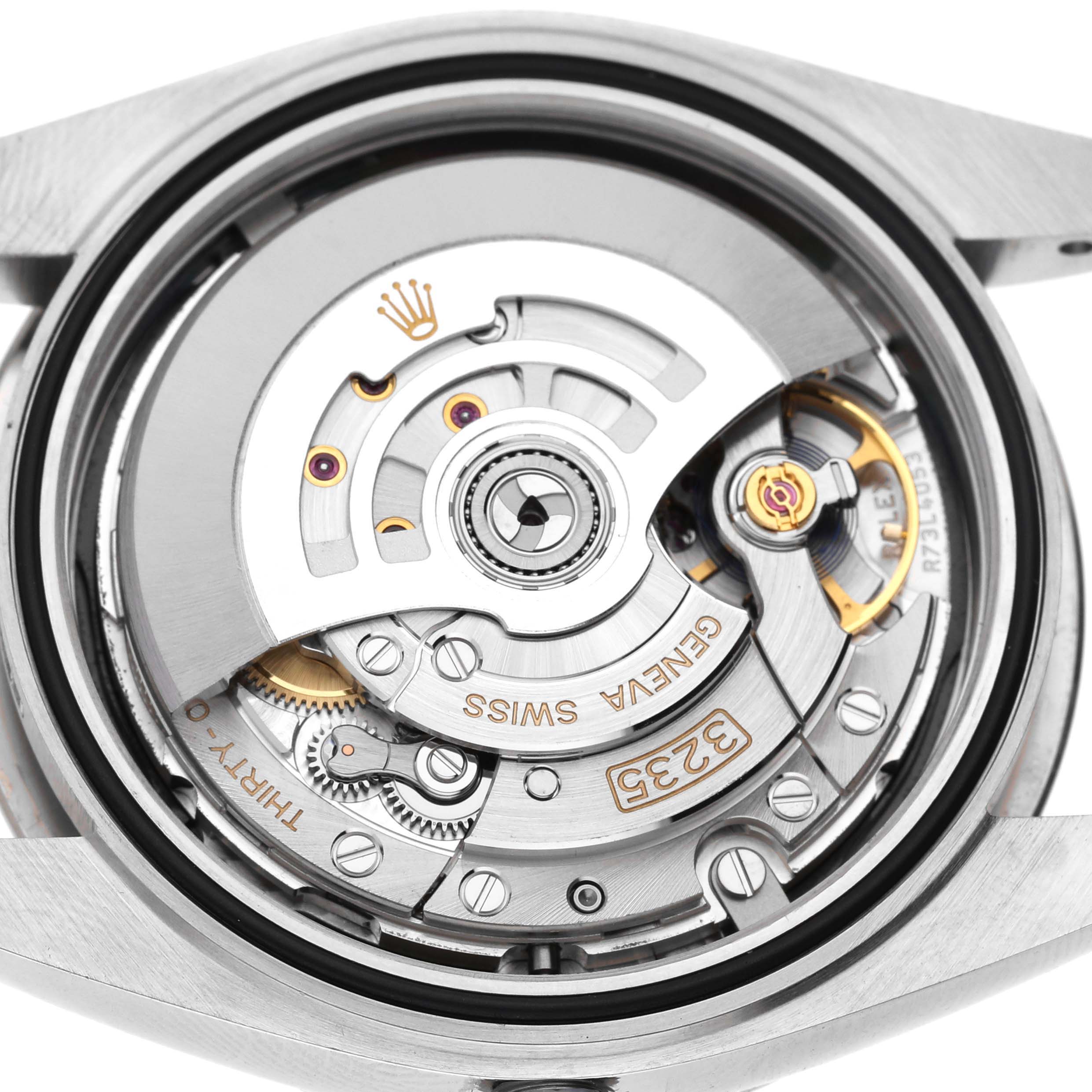 The image shows the back view of a Rolex Datejust 41 M126334-0018 Men's Stainless Steel Black Dial, highlighting its intricate movement and rotor.