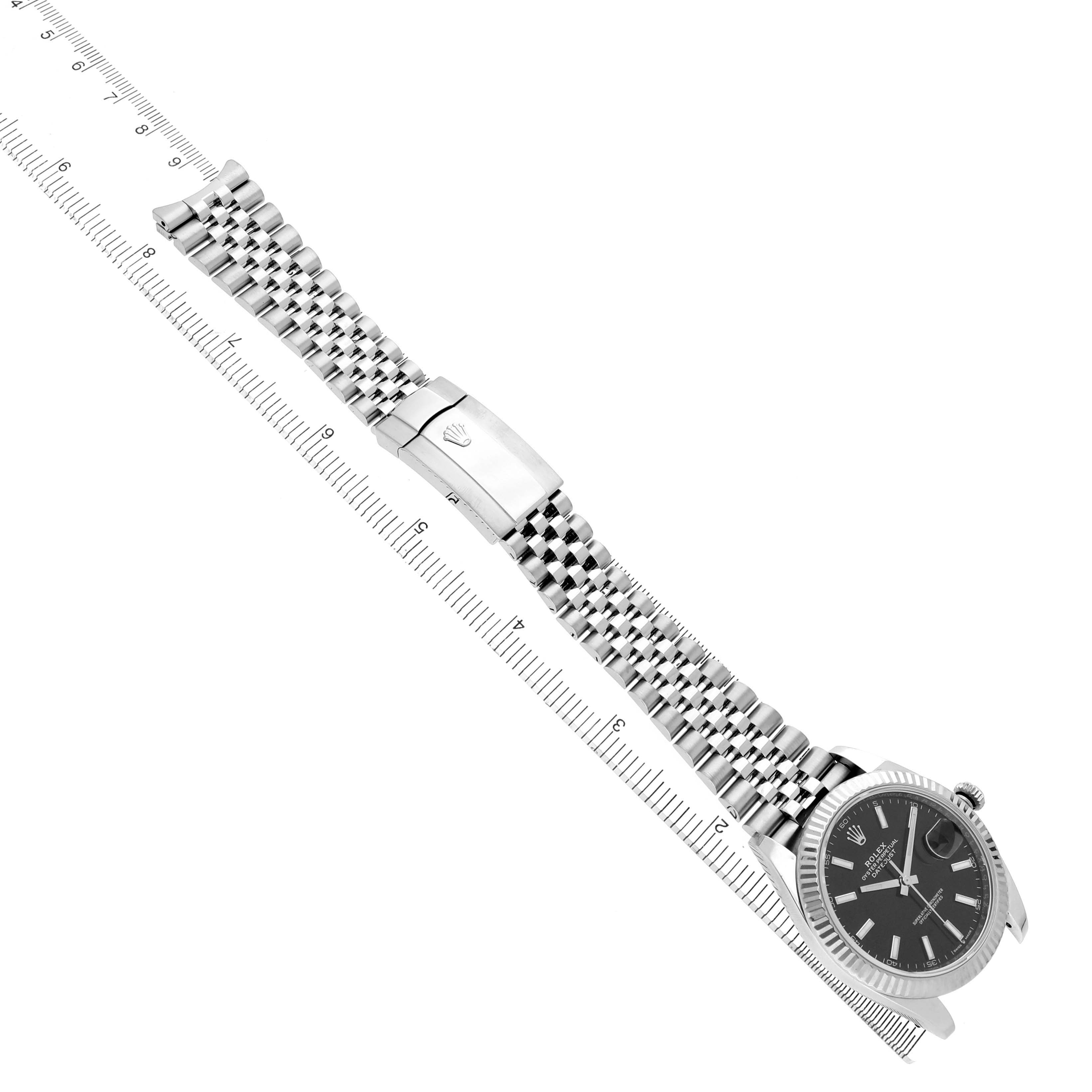 The Rolex Datejust 41 M126334-0018 Men's Stainless Steel Black Dial is shown at an angle displaying the dial, fluted bezel, and Jubilee bracelet with the clasp visible.