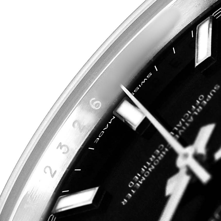 The image shows a close-up of the bezel, part of the dial, and hands of a Rolex Datejust 41 M126334-0018 Men's Stainless Steel Black Dial.
