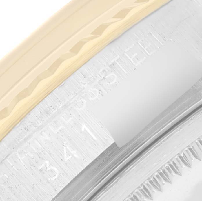 This image shows a close-up view of the Rolex Datejust 1601 Men
s Steel and Gold (two tone) Champagne Dial 1601 Men
s Steel and Gold (two tone) Champagne Dial model
s bezel and part of the case with engravings.