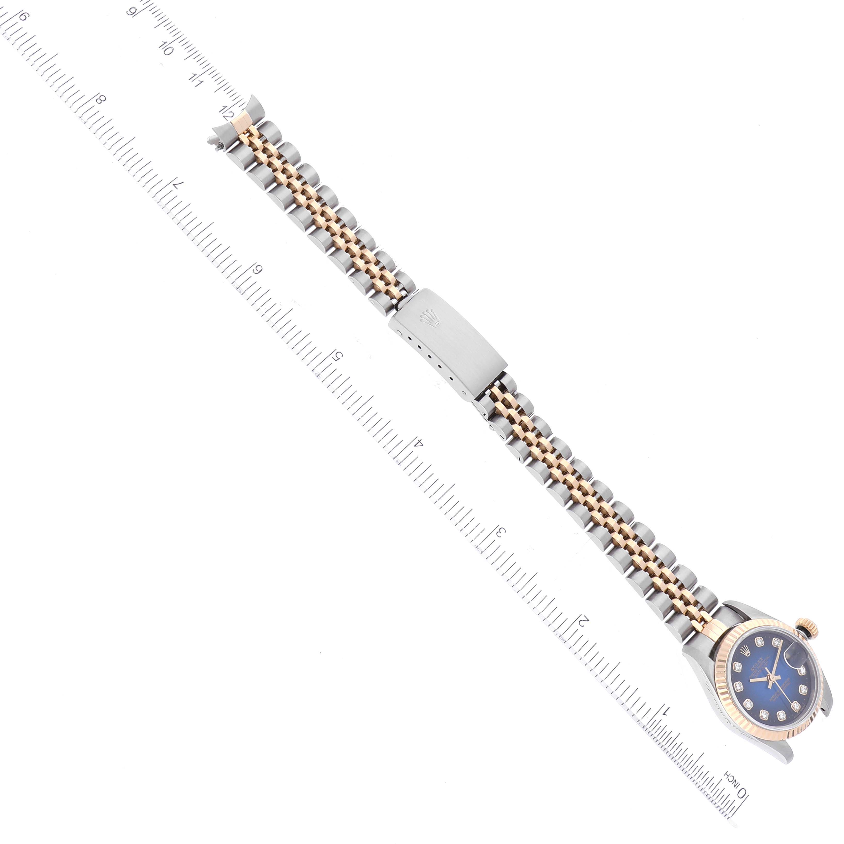 The image shows a Rolex Datejust 69173 Women's Steel and Gold (two tone) Blue Dial 69173 Women's Steel and Gold (two tone) Blue Dial's watch band and clasp, with the dial partially visible, laid next to a measurement ruler.