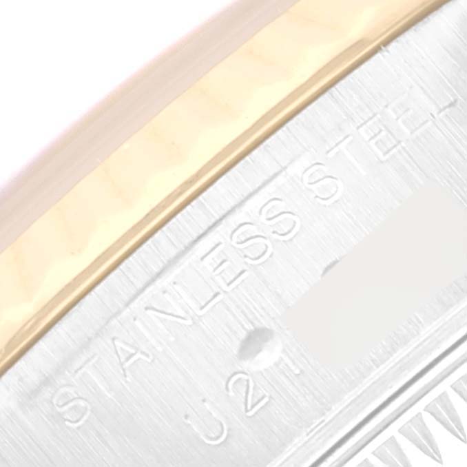 This close-up image of the Rolex Datejust 69173 Women's Steel and Gold (two tone) Blue Dial 69173 Women's Steel and Gold (two tone) Blue Dial watch shows part of the bezel and the engraved stainless steel marking.
