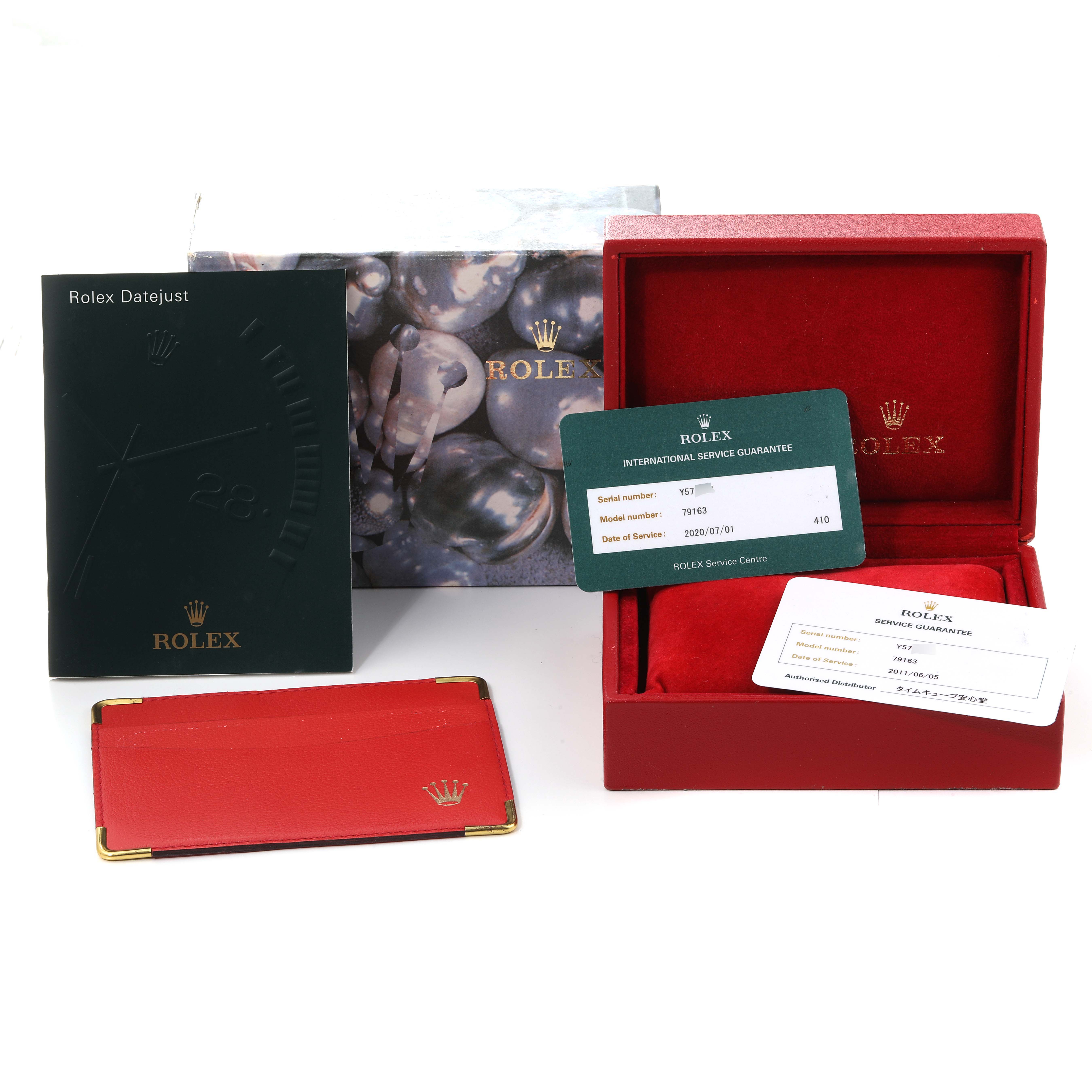 This image shows the Rolex Datejust 79163 Women's Steel and Gold (two tone) White Dial 79163 Women's Steel and Gold (two tone) White Dial accessories including a box, guarantee cards, booklet, and cardholder.