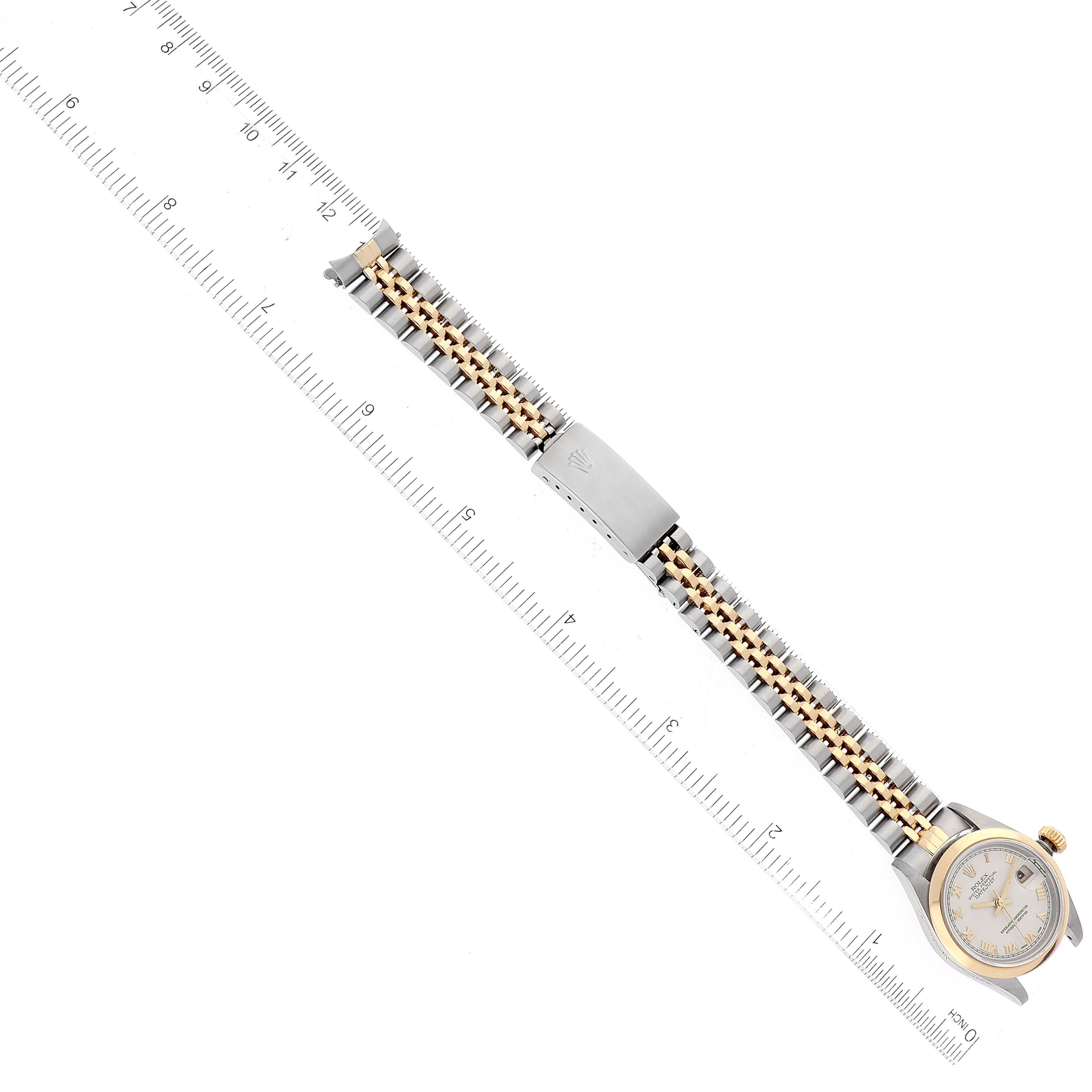 This image shows a top-down view of a Rolex Datejust 79163 Women's Steel and Gold (two tone) White Dial 79163 Women's Steel and Gold (two tone) White Dial watch with a ruler for size reference.