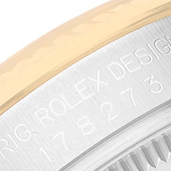 This close-up image shows the case back of a Rolex Mid-Size 178273 Women
s Steel and Gold (two tone) Silver Dial 178273 Women
s Steel and Gold (two tone) Silver Dial model, detailing the engraved text and part of the bezel.