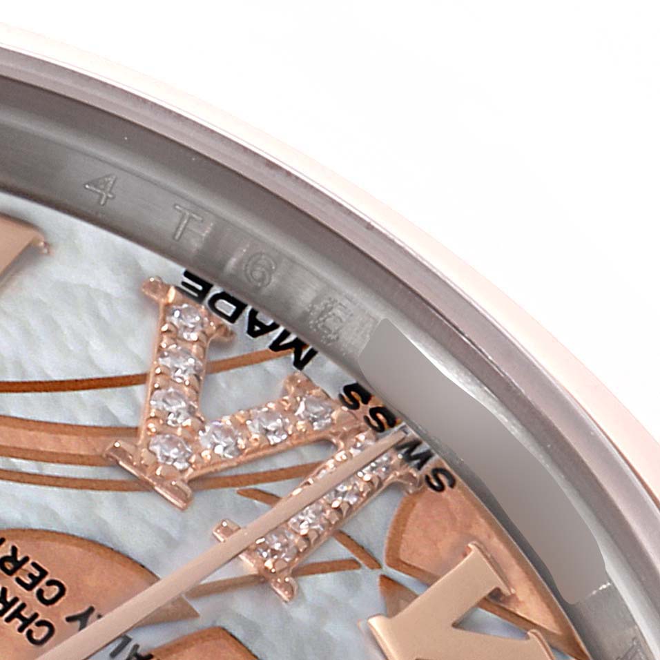 This close-up image of the Rolex Mid-Size 178241 Women's Steel and Gold (two tone) Mother of Pearl Dial 178241 Women's Steel and Gold (two tone) Mother of Pearl Dial model watch shows part of the dial with gem-set hour markers and a section of the bezel.