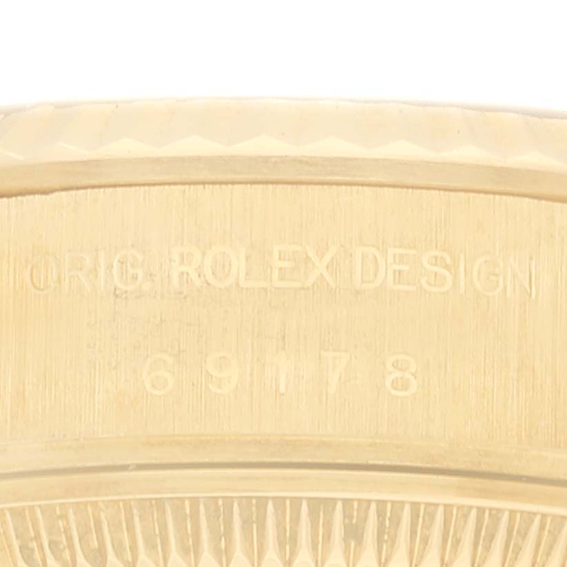 The image shows a close-up of the engraved text on the side casing of a Rolex President 69178 Women
s Yellow Gold Champagne Dial 69178 Women
s Yellow Gold Champagne Dial model.