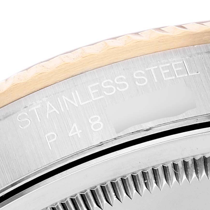 This image shows a close-up of the side case and bezel of a Rolex Datejust 16233 Men's Steel and Gold (two tone) Blue Dial 16233 Men's Steel and Gold (two tone) Blue Dial model, highlighting the "STAINLESS STEEL" engraving.