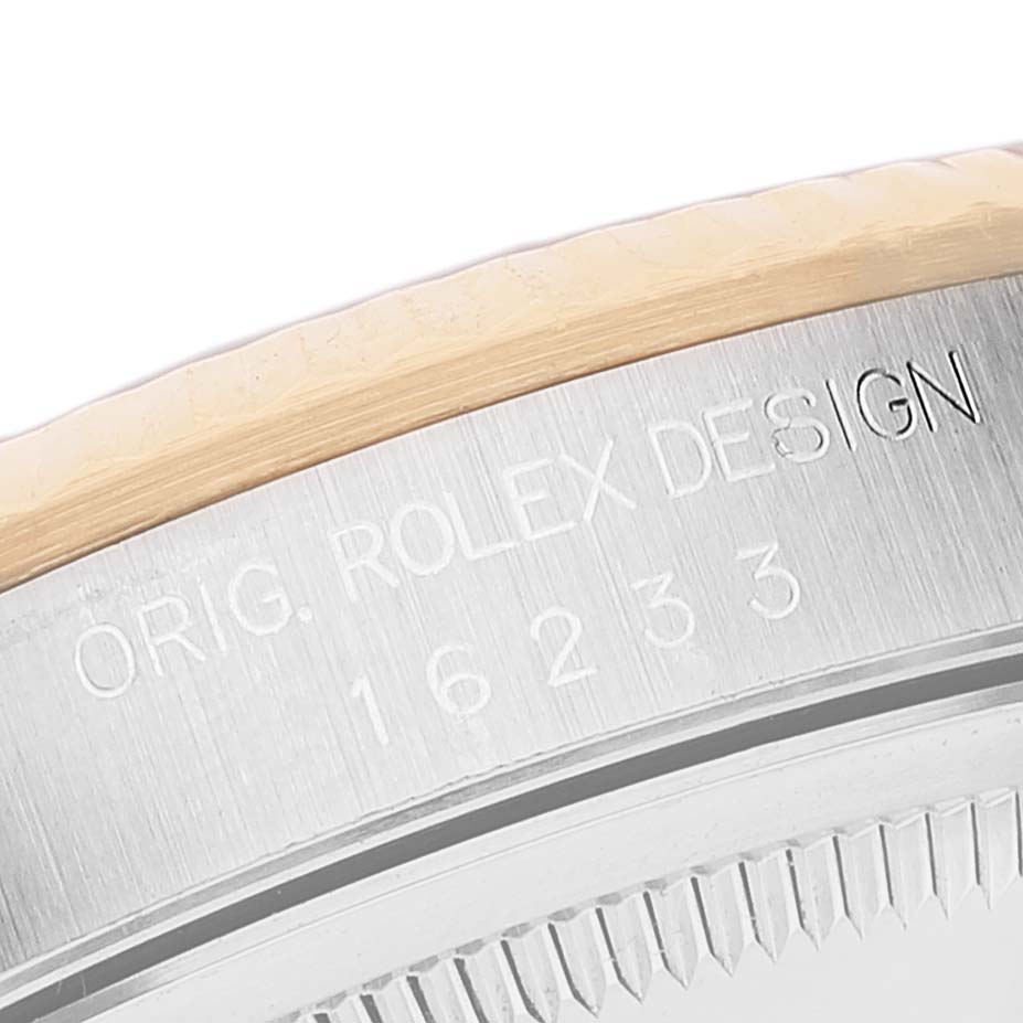 This close-up image shows the engraved bezel of a Rolex Datejust 16233 Men's Steel and Gold (two tone) Blue Dial 16233 Men's Steel and Gold (two tone) Blue Dial watch.