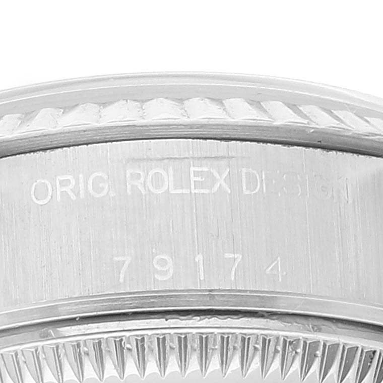 The image shows a close-up of the side of a Rolex Datejust 79174 Women's Stainless Steel Black Dial 79174 Women's Stainless Steel Black Dial model, highlighting the bezel and the engraved model number.