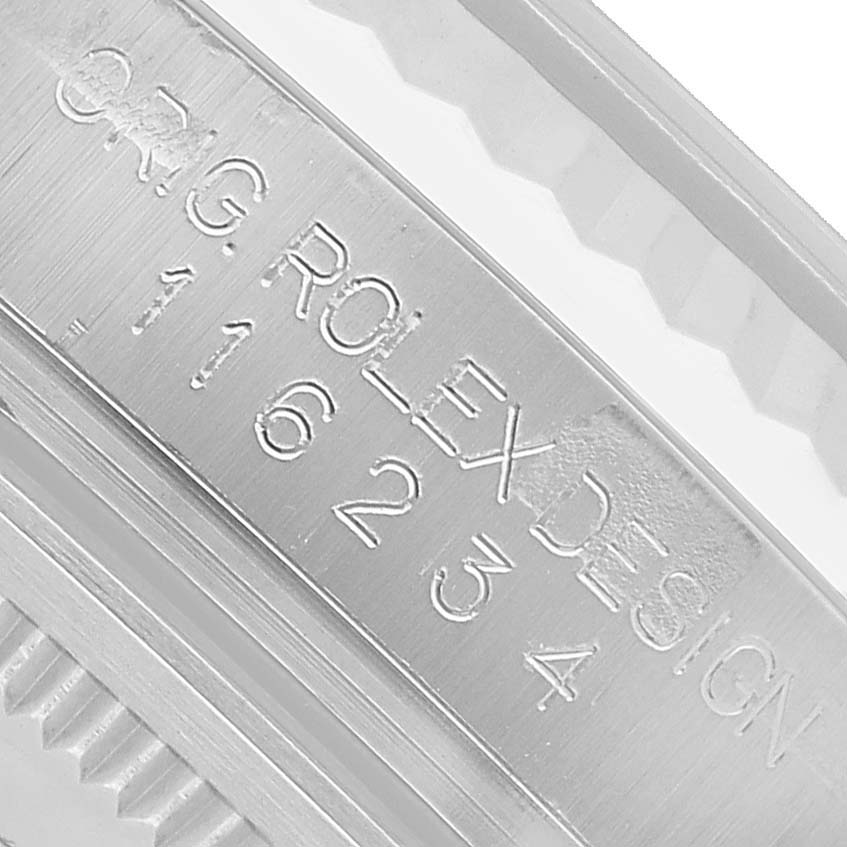 The image shows a close-up of the engraving on the side of the Rolex Datejust 116234 Men's Stainless Steel Silver Dial watch case.