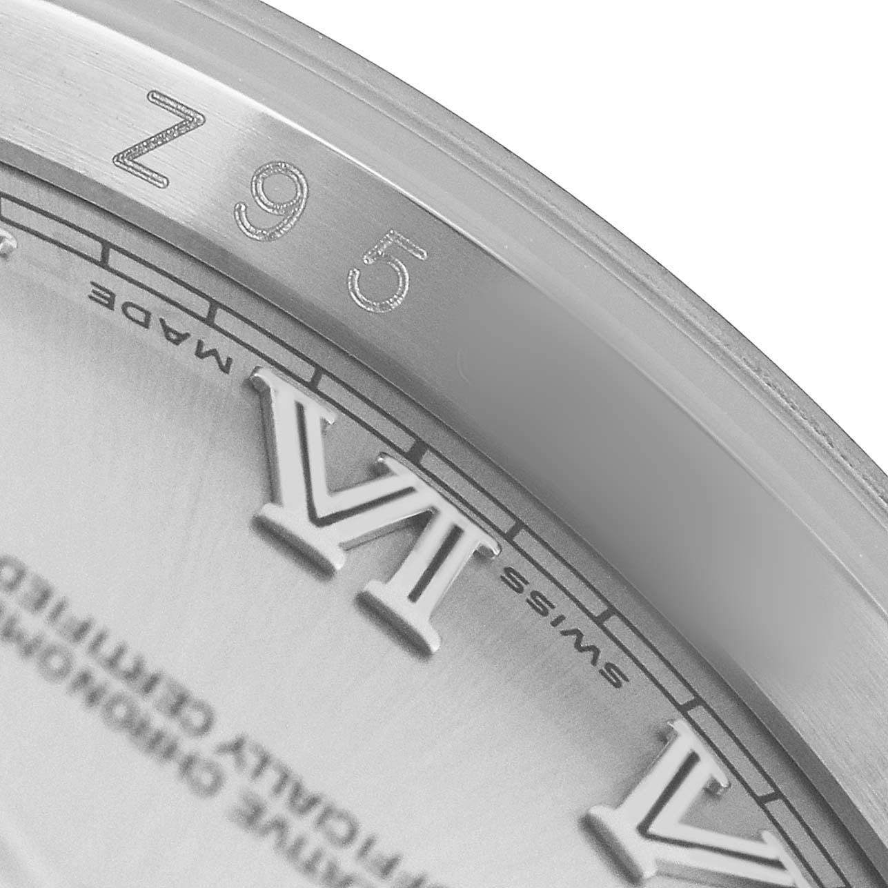 The image shows a close-up of the dial edge and Roman numerals of a Rolex Datejust 116234 Men's Stainless Steel White Dial watch, focusing on the "VI".