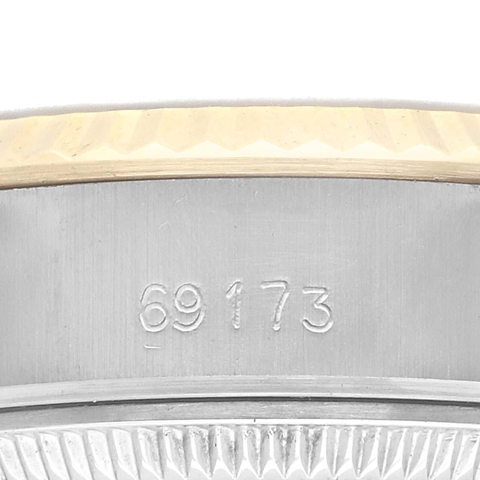 The image shows a close-up of the side of a Rolex Datejust 69173 Women
s Steel and Gold (two tone) Champagne Dial 69173 Women
s Steel and Gold (two tone) Champagne Dial watch, featuring the model number and the bezel edge.