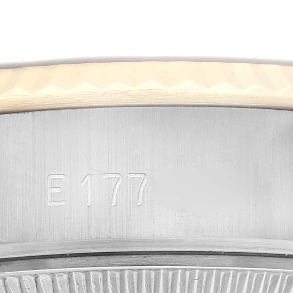 The image shows the side of the Rolex Datejust 69173 Women
s Steel and Gold (two tone) Champagne Dial 69173 Women
s Steel and Gold (two tone) Champagne Dial watch case, highlighting the serial number area.