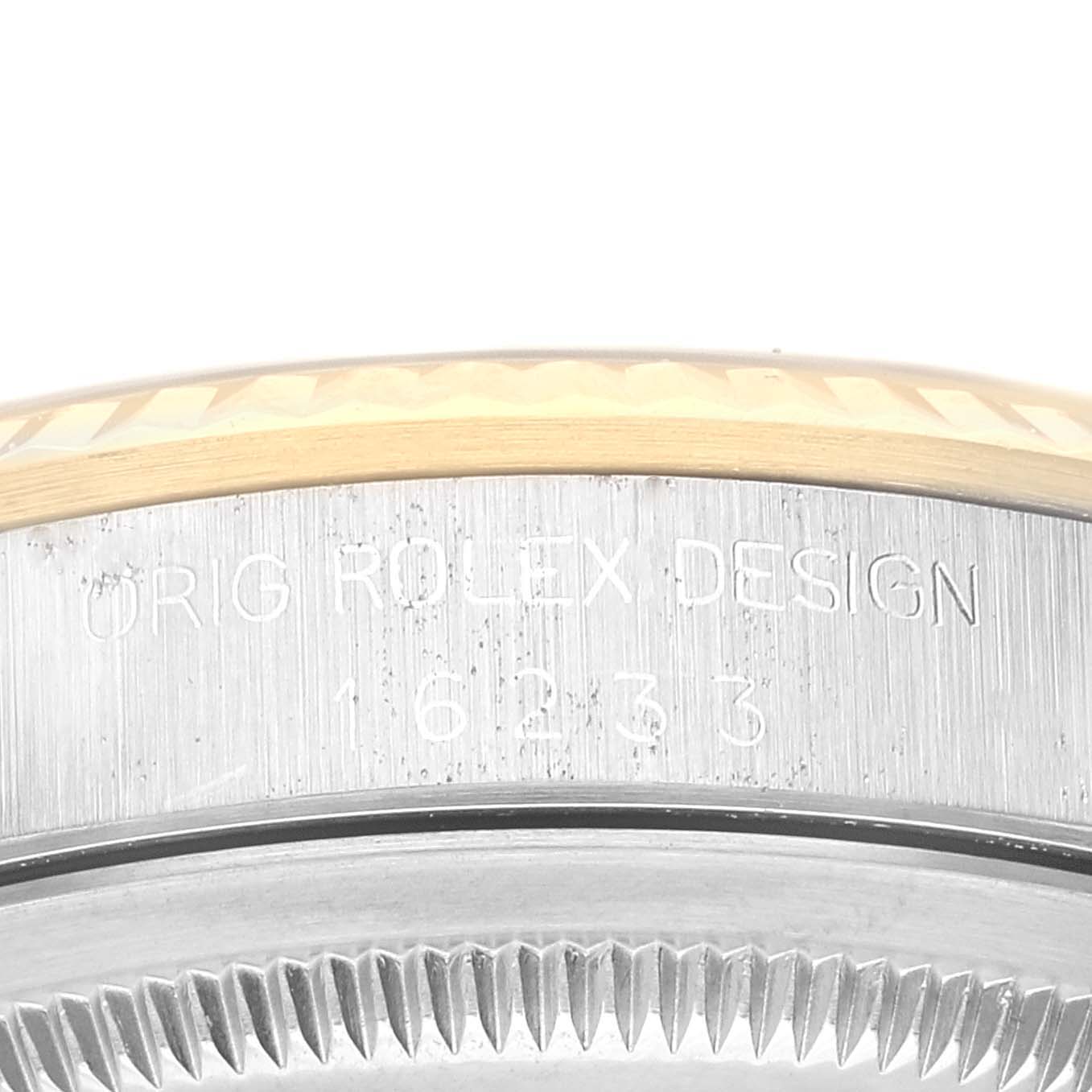 The image shows a close-up view of the Rolex Datejust 16233 Men's Steel and Gold (two tone) Black Dial 16233 Men's Steel and Gold (two tone) Black Dial watch's bezel and case, focusing on the engraved model number and design text on the case.