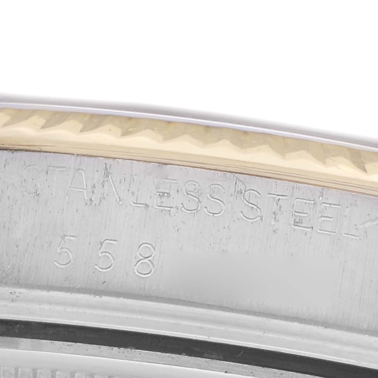 The image shows a close-up of the rim of a Rolex Vintage Collection 16013 Men
s Steel and Gold (two tone) Black Dial 16013 Men
s Steel and Gold (two tone) Black Dial watch case, highlighting the "stainless steel" engraving.