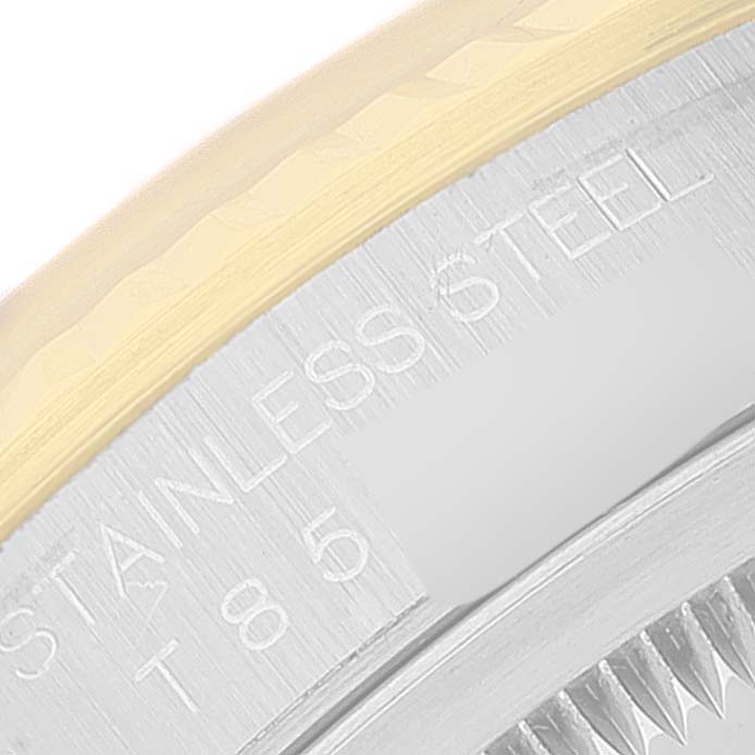 This close-up image of a Rolex Datejust 16233 Men's Steel and Gold (two tone) Black Dial 16233 Men's Steel and Gold (two tone) Black Dial watch shows part of the bezel and the “STAINLESS STEEL” engraving on the case.