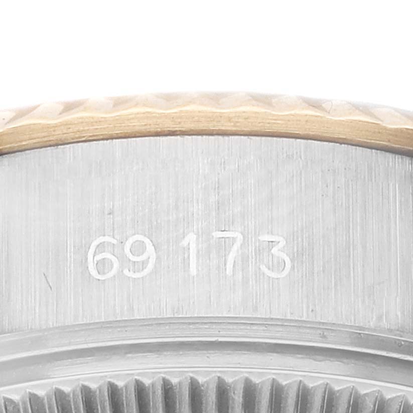 This close-up image of the Rolex Datejust 69173 Women's Steel and Gold (two tone) Champagne Dial 69173 Women's Steel and Gold (two tone) Champagne Dial watch shows part of the side case, including the fluted bezel and serial number "69173."