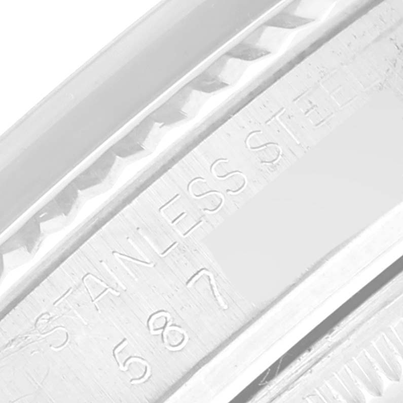 The image shows a close-up of the inner clasp area of a Rolex Datejust 16014 Men's Stainless Steel Black Dial 16014 Men's Stainless Steel Black Dial watch, revealing the engraving "STAINLESS STEEL" and the number "587".
