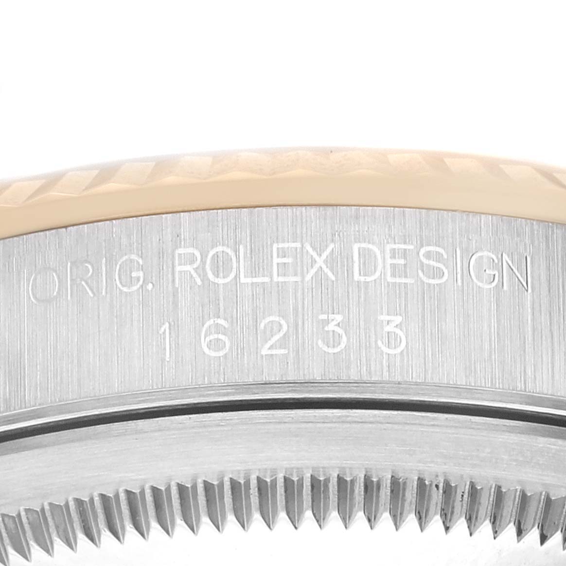 The image shows a close-up of the engraved case side and bezel teeth of a Rolex Datejust 16233 Men's Steel and Gold (two tone) White Dial 16233 Men's Steel and Gold (two tone) White Dial model.