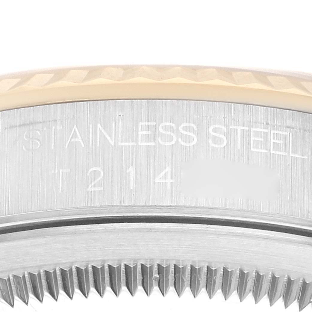 This close-up image shows the side of a Rolex Datejust 16233 Men's Steel and Gold (two tone) White Dial 16233 Men's Steel and Gold (two tone) White Dial watch, highlighting the stainless steel case and engravings.