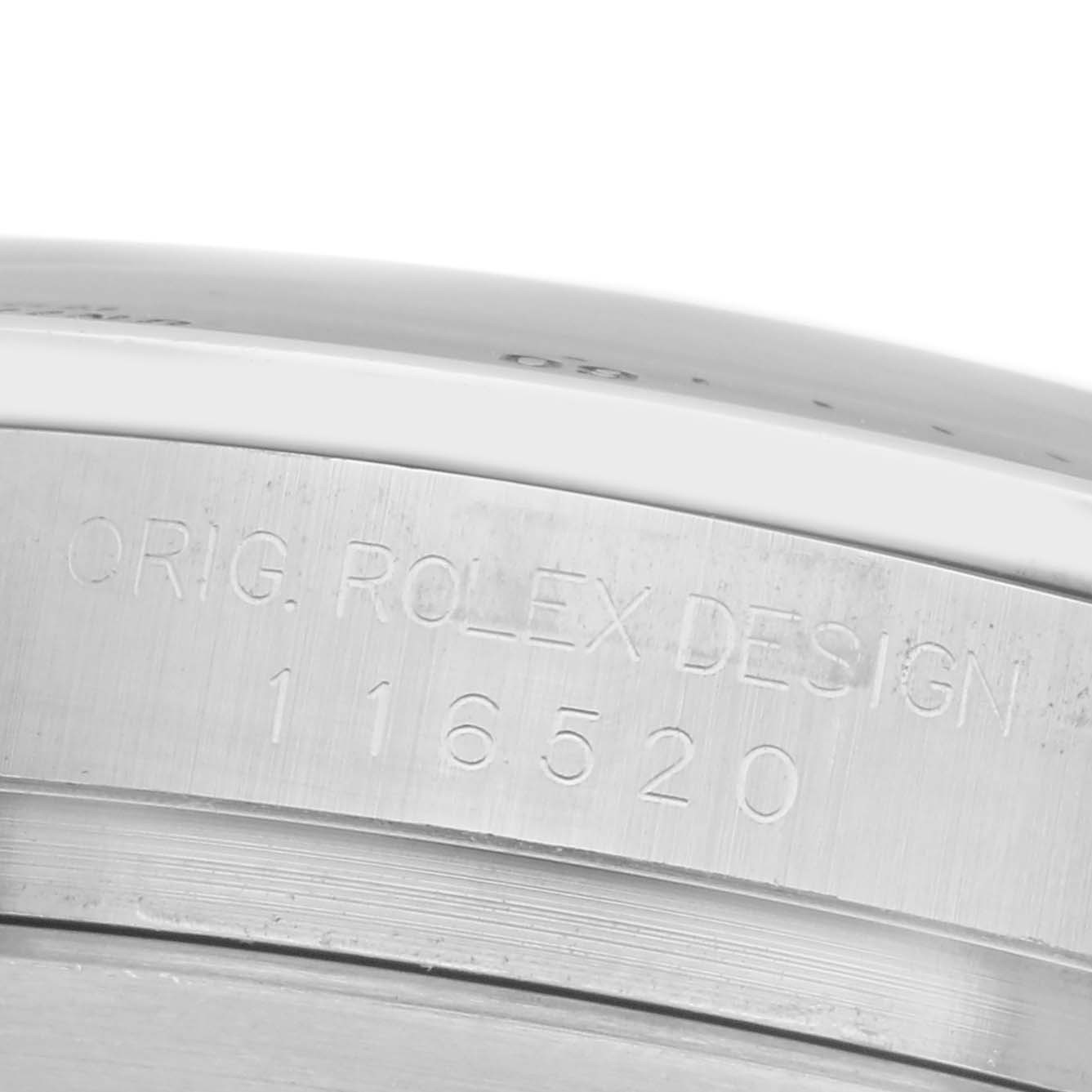 The image shows a close-up of the side of a Rolex Daytona 116520 Men
s Stainless Steel White Dial 116520 Men
s Stainless Steel White Dial watch, focusing on the engraved model number and "Orig. Rolex Design."