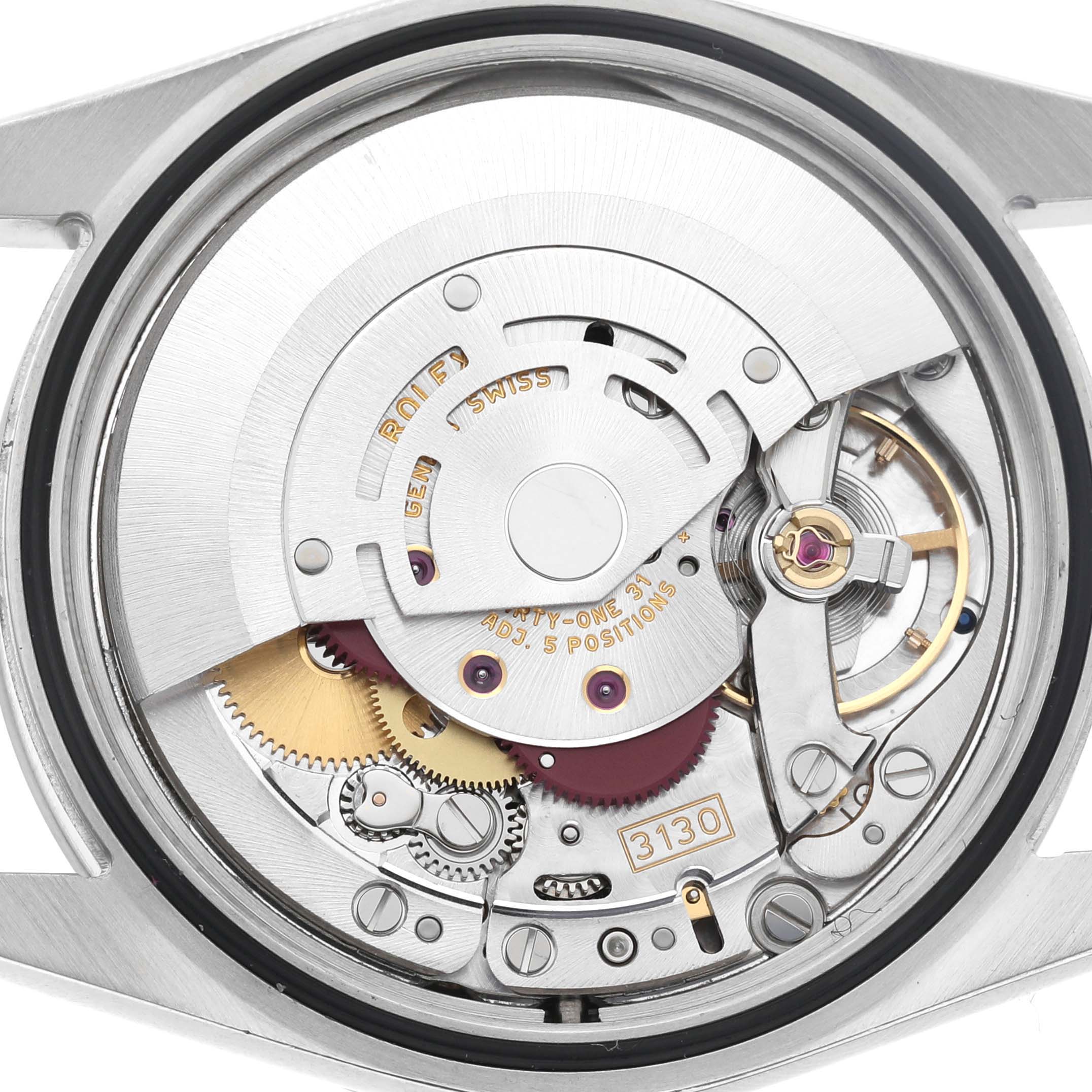 The image shows the internal movement of a Rolex Explorer 114270 Men's Stainless Steel Black Dial watch, highlighting gears and the balance wheel.