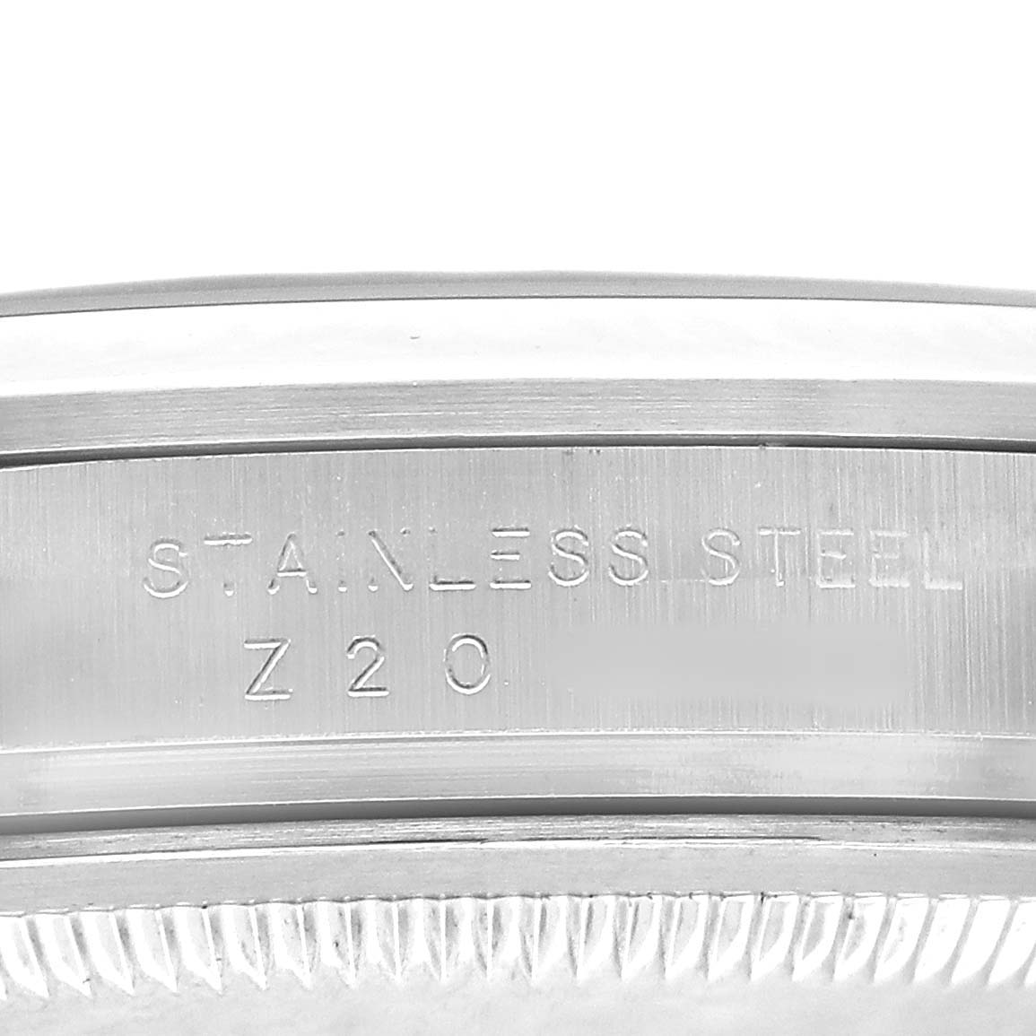 The image shows a close-up of the side of the bezel with "STAINLESS STEEL" engraved on the Rolex Explorer 114270 Men's Stainless Steel Black Dial model.