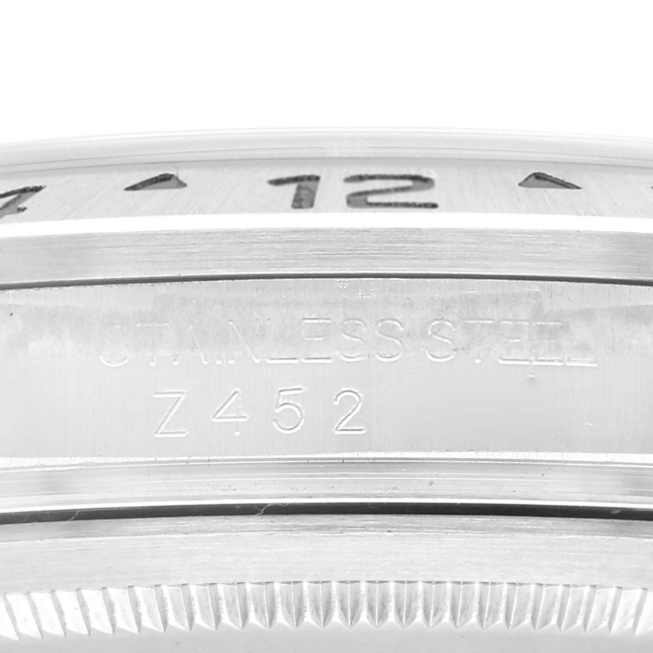 The image shows a close-up of the side of a Rolex Explorer 16570 Men
s Stainless Steel Black Dial 16570 Men
s Stainless Steel Black Dial watch, displaying the stainless steel marking and part of the bezel.