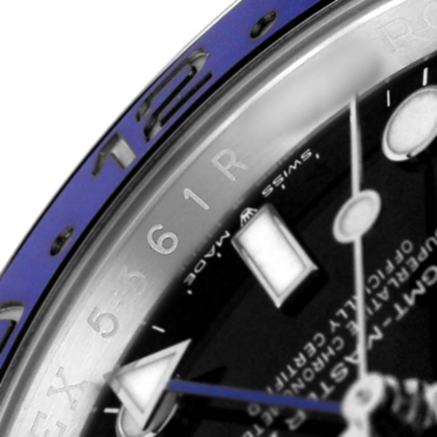 The image shows a close-up of the Rolex GMT-Master M126710BLNR-0003 Men's Stainless Steel Black Dial's bezel and a portion of the dial and hands.
