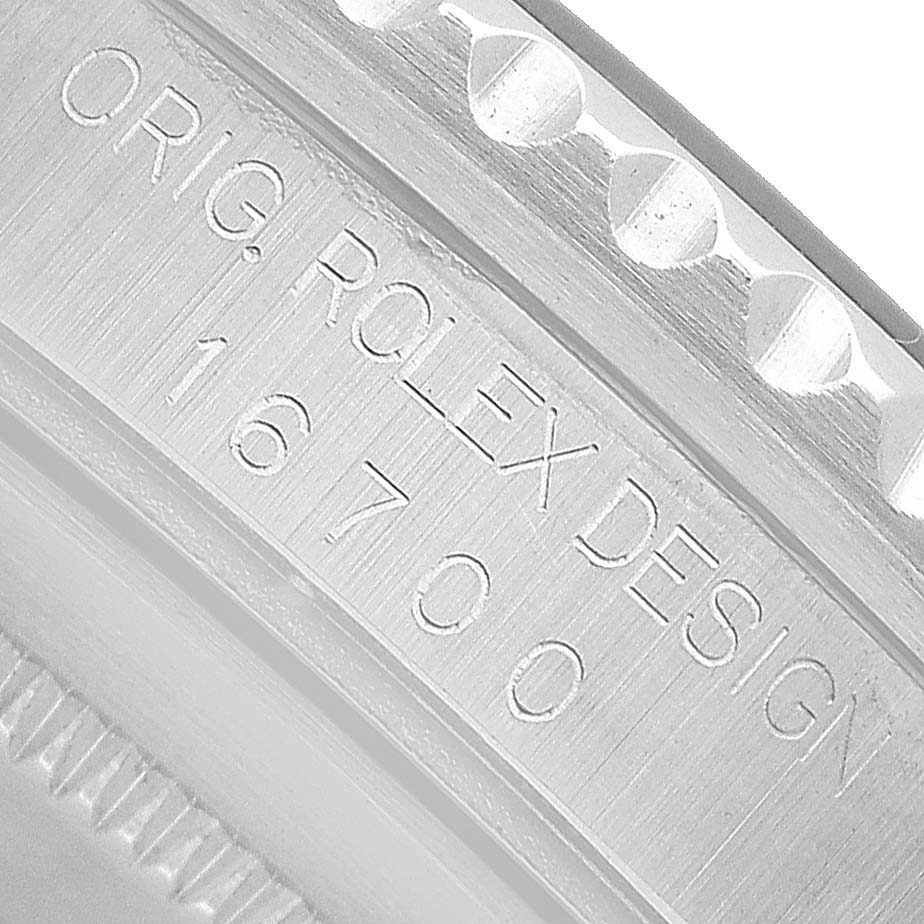 The image shows a close-up of the Rolex Yacht-Master 16700 Men's Stainless Steel Black Dial's case side, highlighting the engraved design number.