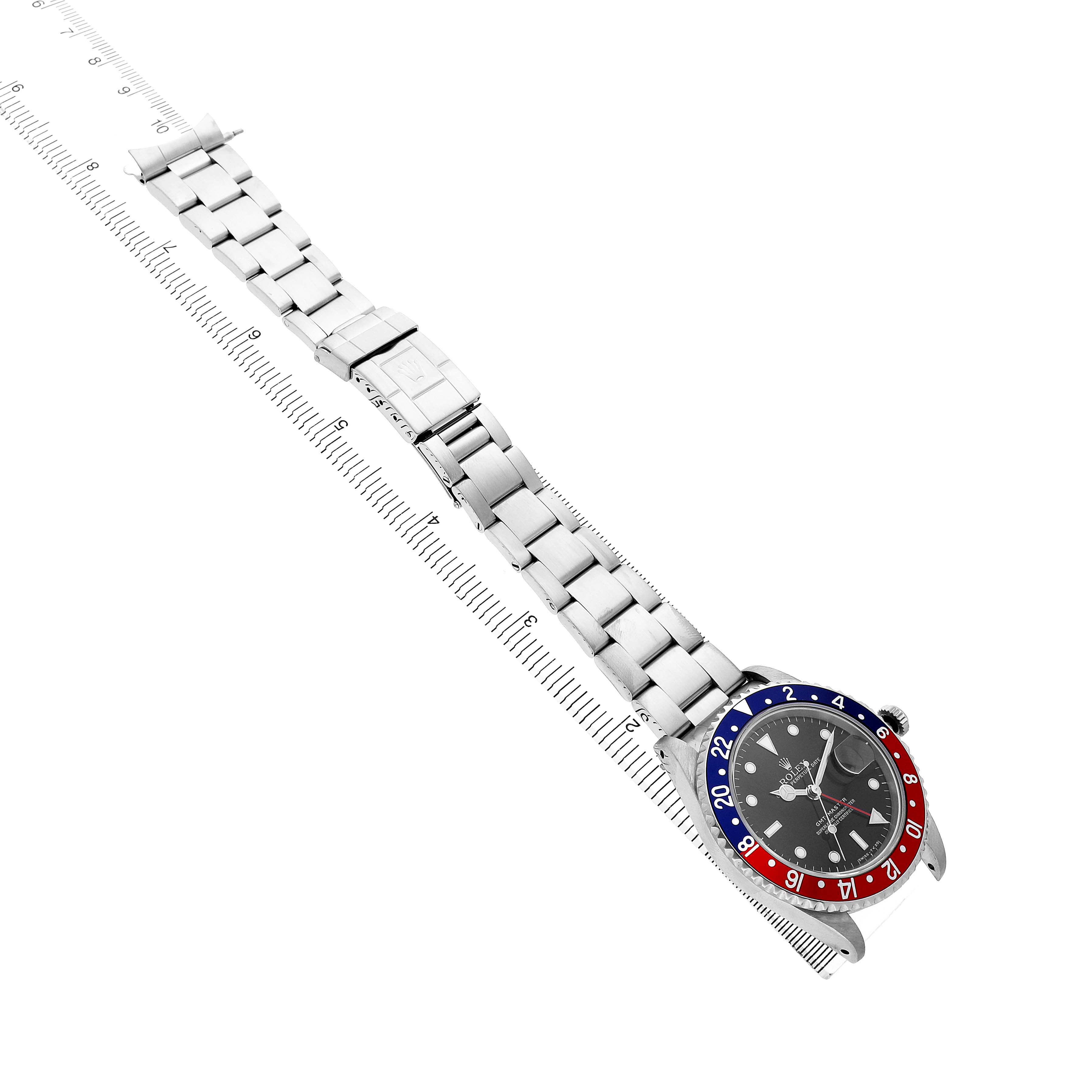 The image shows a Rolex Yacht-Master 16700 Men's Stainless Steel Black Dial watch at an angled top view, displaying the bezel, dial, and full bracelet with a measuring guide.