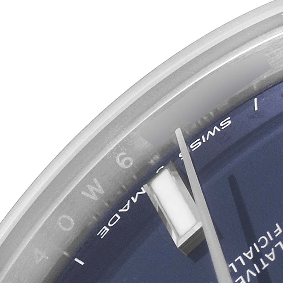The image shows a close-up of the number 
6,
 part of the dial, and the minute hand of a Rolex Mid-Size 277200 Women
s Stainless Steel Blue Dial 277200 Women
s Stainless Steel Blue Dial watch.
