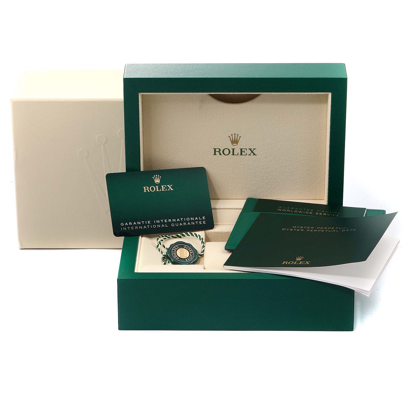 The image shows a Rolex Mid-Size 277200 Women
s Stainless Steel Pink Dial 277200 Women
s Stainless Steel Pink Dial watch box with a warranty card, booklets, and a tag in a green and beige display.