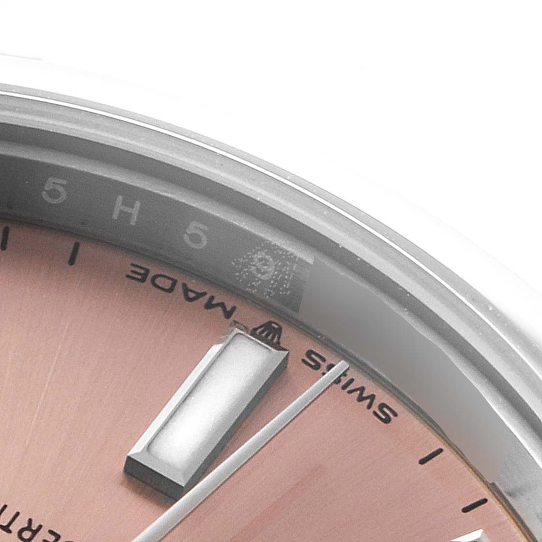 This close-up image shows part of the dial and the bezel, indicating the "Swiss Made" label of a Rolex Mid-Size 277200 Women
s Stainless Steel Pink Dial 277200 Women
s Stainless Steel Pink Dial model watch.