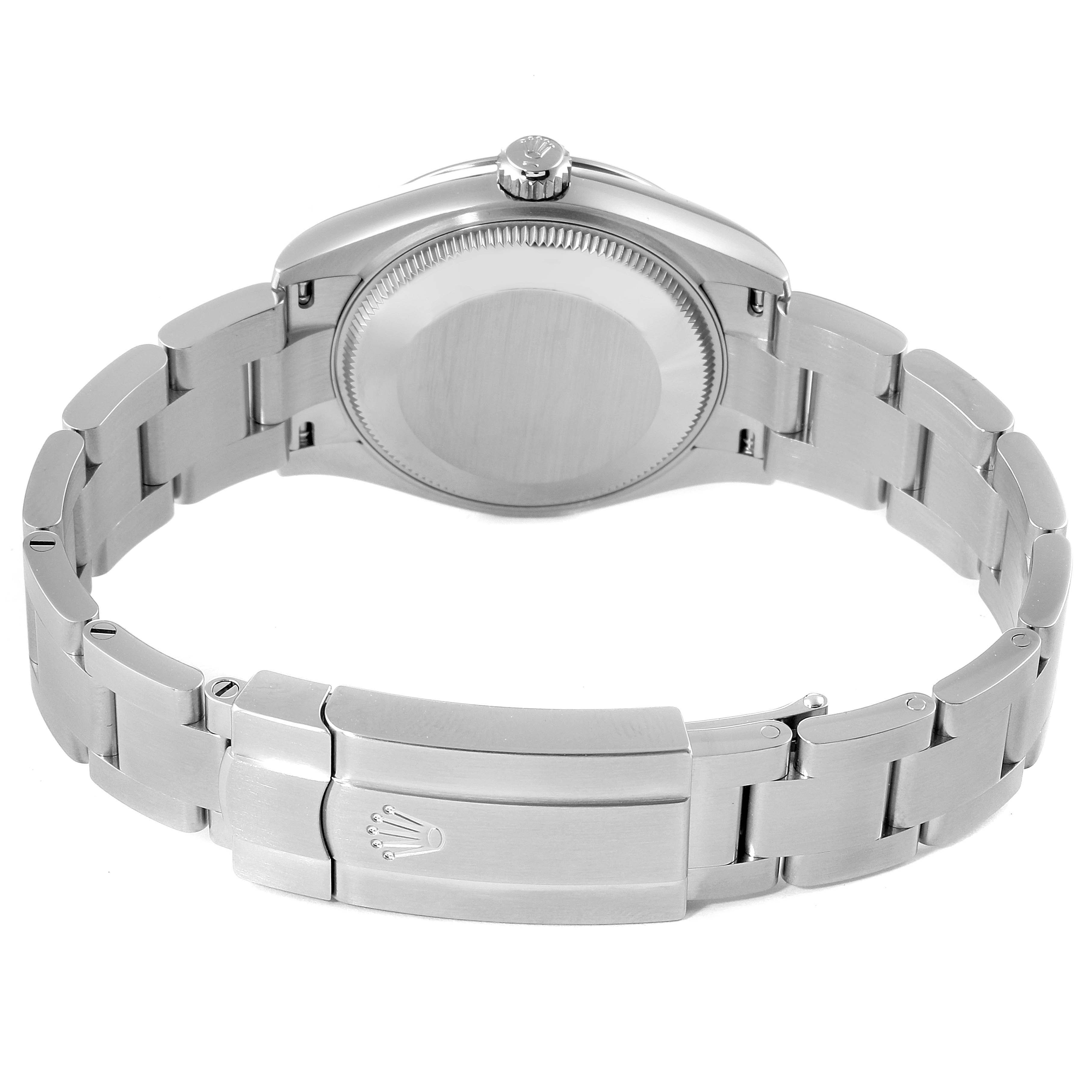 The image shows the back view of a Mid-Size Rolex watch, highlighting the case back and stainless steel bracelet with clasp.