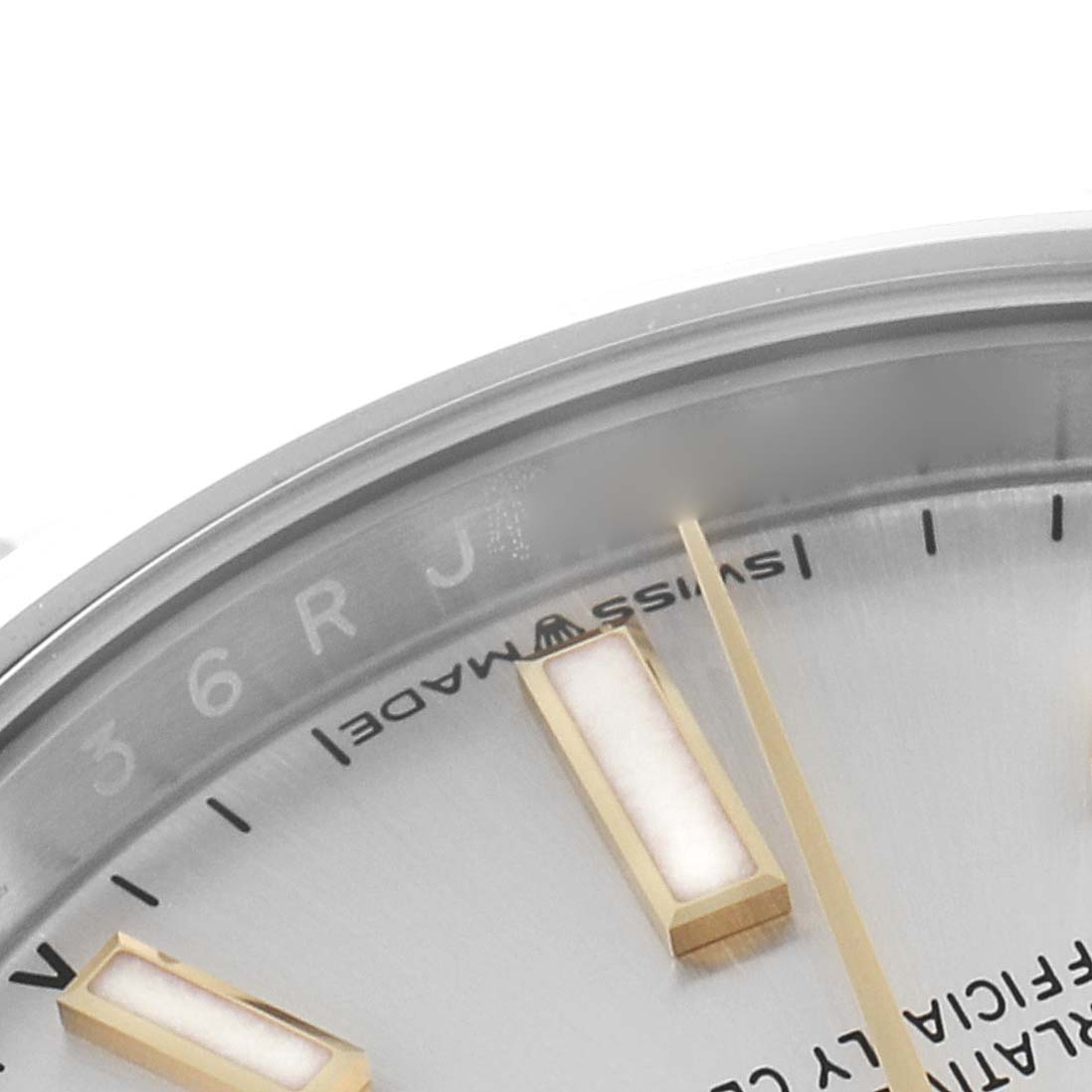 The image shows a close-up of a portion of the dial and markers of a Rolex Oyster Perpetual 124200 Men's Stainless Steel Silver Dial 124200 Men's Stainless Steel Silver Dial watch, focusing on the "Swiss Made" text.