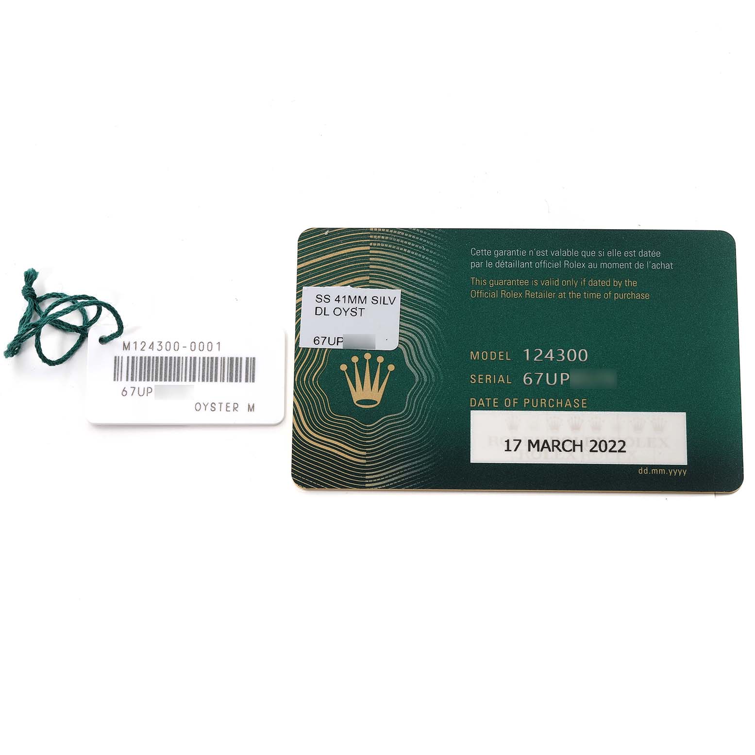 The image shows a warranty card and a tag for the Oyster Perpetual model by Rolex, including model and serial numbers.