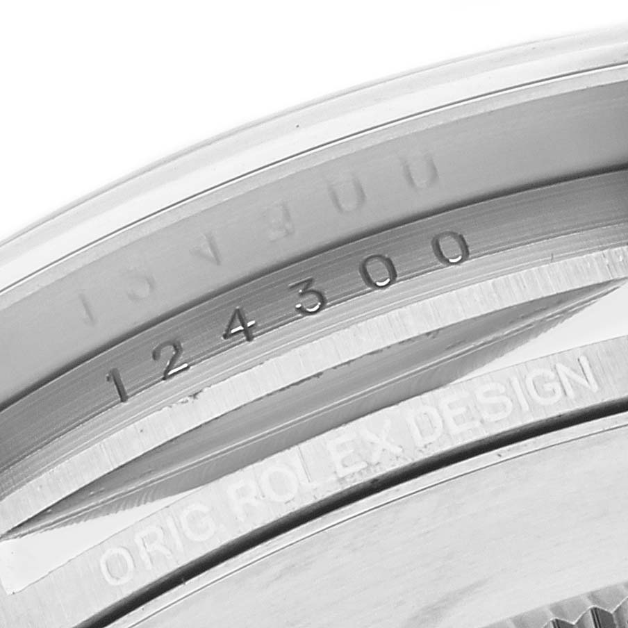 The close-up image shows the serial number engraving on the case of a Rolex Oyster Perpetual 124300 Men's Stainless Steel Silver Dial 124300 Men's Stainless Steel Silver Dial watch.