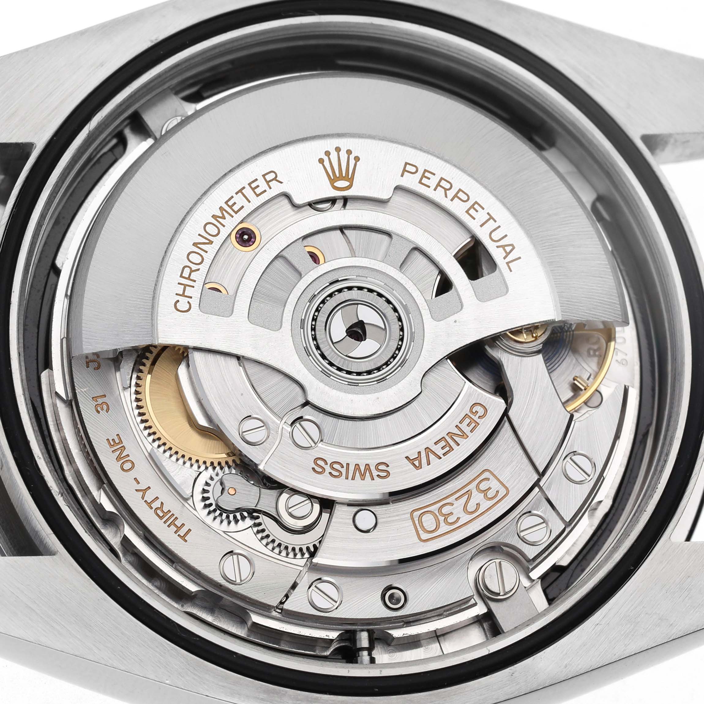 The image shows the movement of a Rolex Oyster Perpetual M124300-0002 Men's Stainless Steel Black Dial, highlighting its internal mechanical components from the back.
