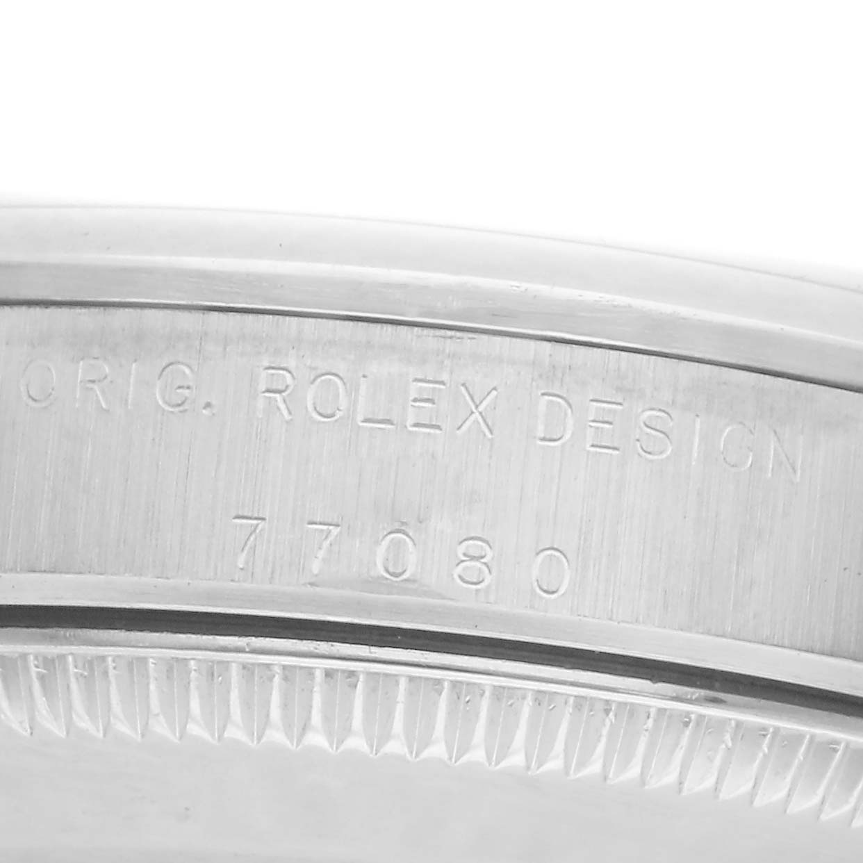 The image shows a close-up side view of the case back engraving on a Rolex Mid-Size 77080 Women
s Stainless Steel White Dial 77080 Women
s Stainless Steel White Dial model watch.